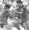 Marc Glanville tries to get past Wayne Pearce.