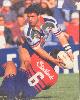 Phil Blake offloads in a Matthew Johns tackle.
