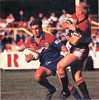 Andrew Johns steps past Greg Florimo.