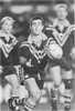 Andrew Johns passes, in the midst of a 32 point haul.