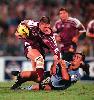 Andrew Johns tackles Jason Smith.