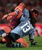 Adam Muir and Jamie Ainscough tackle Gary Larson.