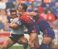 Keith Beauchamp smashes into Ken McGuiness.