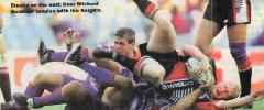 Michael Buettner is tackled by Bill Peden.