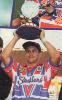 Matthew Johns hoists the cup high.
