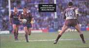 Matthew Johns threads a kick through the Manly defensive line.
