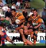 Asa Milford is tackled down low by Paul Harragon.