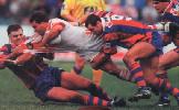 Paul Harragon, Lee Jackson and Tony Butterfield fling Wayne Bartrim to the turf.