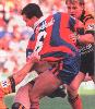 Matthew Johns is pulled to ground.