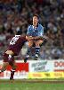 Andrew Johns gets the kick away.