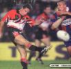 Jason Taylor kicks despite a Neil Piccinelli charge-down.