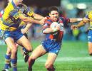 A tryline bound Robbie O'Davis is only just collared by Clinton Schifcofske ...