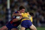 Matthew Gidley is tackled.
