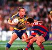 Jarrod McCracken about to be tackled by Andrew Johns.
