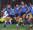 Andrew Johns prepares to pass to a cavalcade of support.