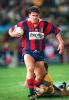 Matthew Gidley nearly slips through the tackle.