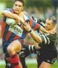 Danny Buderus about to break the attempted Wests tackle.