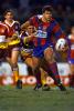 Troy Fletcher brushes off a tackle ...