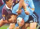 Adam MacDougall is tackled by Rogers.