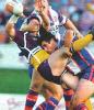 A typical Andrew Johns tackle on Priddis.