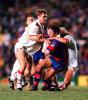 Robbie O'Davis is swamped by Dragon players.