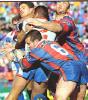 Matthew Johns makes a tackle.