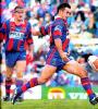 Andrew Johns belts it downfield.