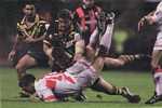 Andrew Johns watches as Robbie Kearns and Shane Webcke complete a tackle.