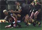 Adam MacDougall and Trent Barrett make a tackle.