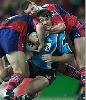 Martin Lang is tackled by Steve Simpson.