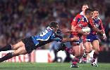 Andrew Johns makes a half break.