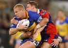 The old hands - Michael Buettner is tackled by Bill Peden.