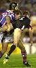 Cliff Beverley is tackled by Clint Newton and Troy Fletcher.