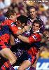 Steven Kearney is tackled by Sean Rudder and Matthew Gidley.