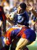 Andrew Pierce is tackled by Bill Peden.
