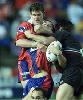 Timana Tahu is tackled high.