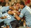 Steve Simpson and Danny Buderus stop Gorden Tallis.