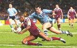 Steve Simpson desperately tries to stop Lote Tuqiri to no avail.