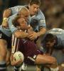 Gorden Tallis is crunched by Steve Simpson and others.