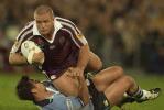 Andrew Johns tackles Shane Webcke unconventionally.
