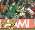 Andrew Johns and Gorden Tallis smash Paul Sculthorpe.