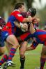 Steve Menzies is crunched by Clint Newton.