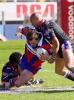 Clint Newton is wrapped up by Jerry Seuseu.