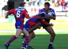 Andrew Johns and Sean Rudder tackle Ali Lauiti'iti.