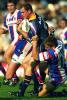 Steve Bell strains to break the tackle.