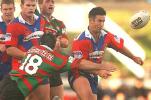 Andrew Johns throws a pass.