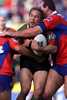 Jason Death is sandwiched by Newcastle defence.
