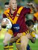 Ben Kennedy is tackled by Luke Ricketson.