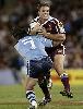 Andrew Johns comes up with a bone-cruncher on Dane Carlaw.