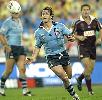 Andrew Johns throws a pass.